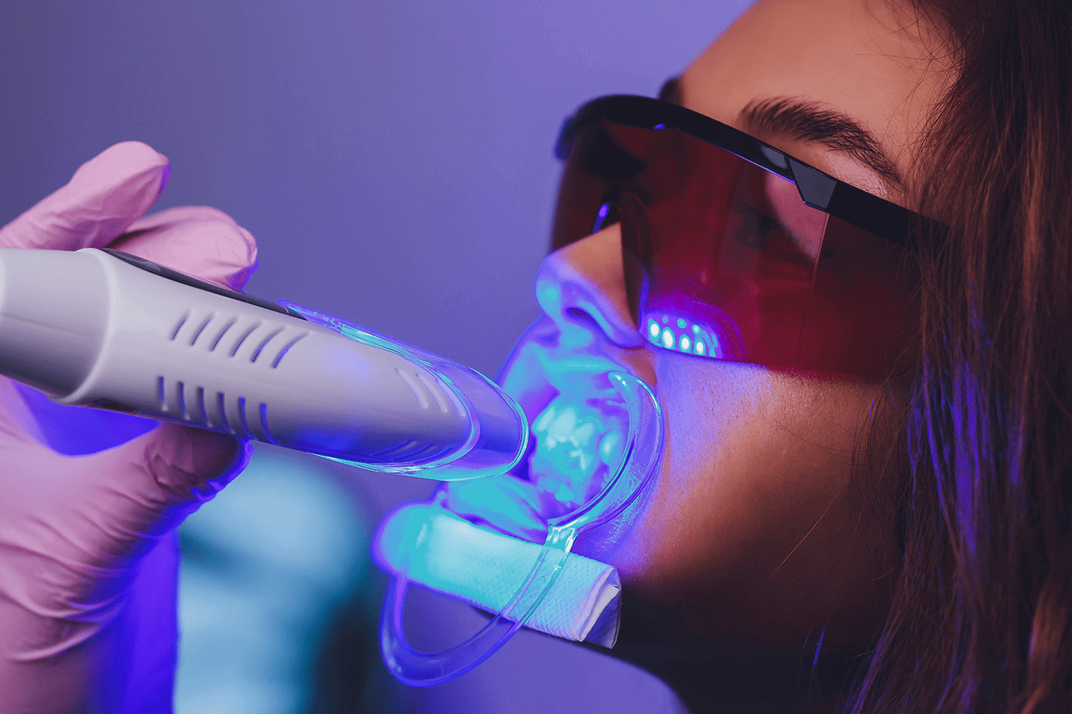 Patient receiving laser teeth whitening treatment